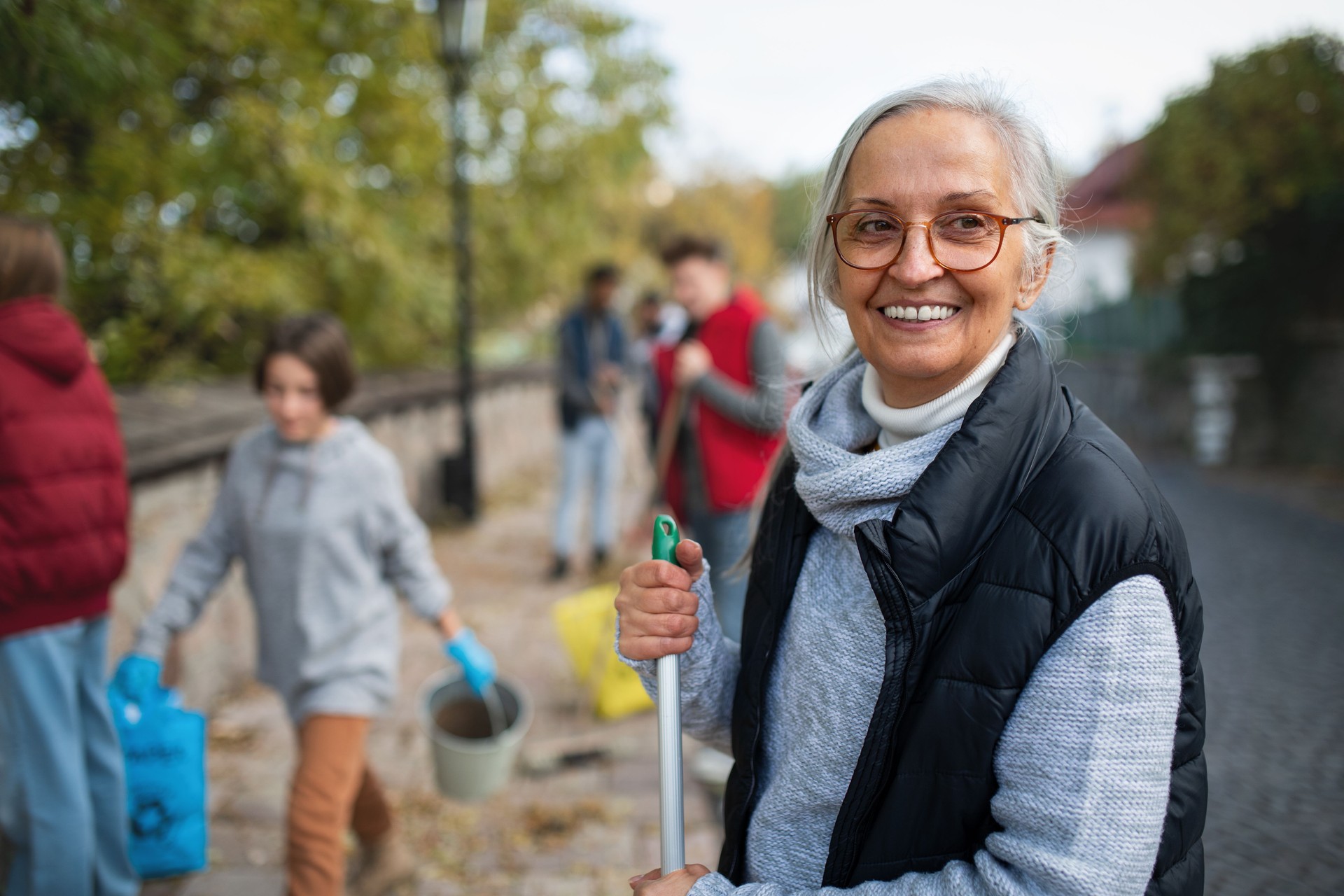 Senior woman volunteer team cleaning up street, community service connection Join  Together  Circle  Team  Support  Community  Connect  Safe  Become a member  Come along